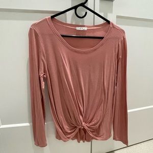 Pink pullover blouse with twisted hem in front